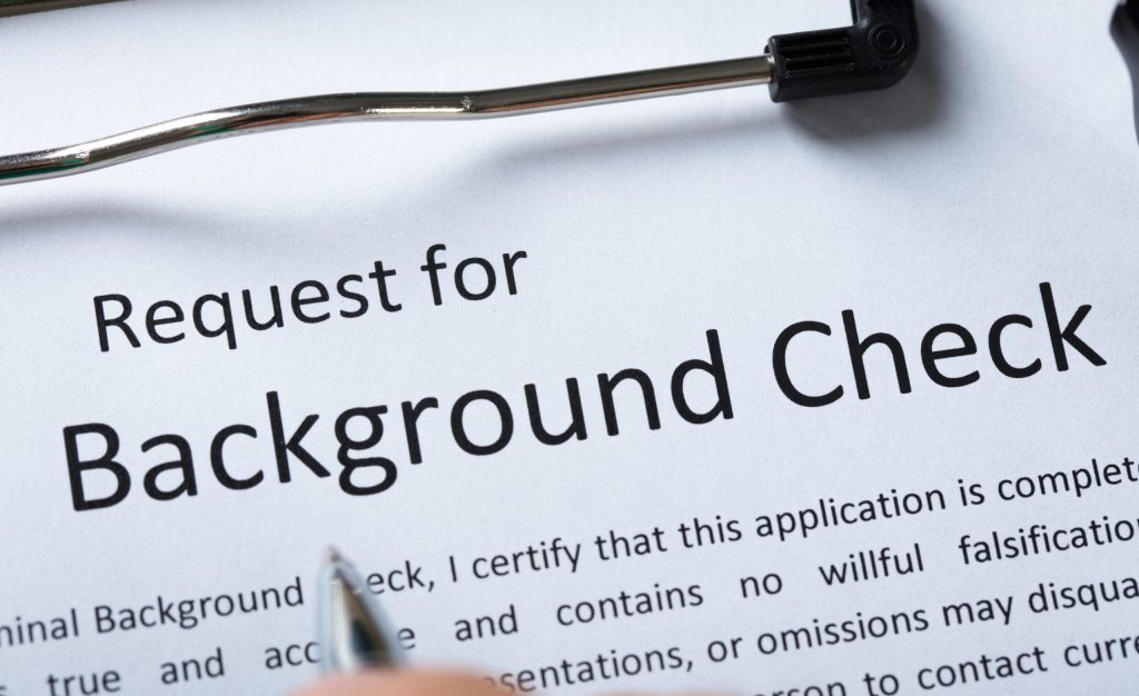 High Angle View Of Criminal Background Check Application Form With Pen for the TREC background check