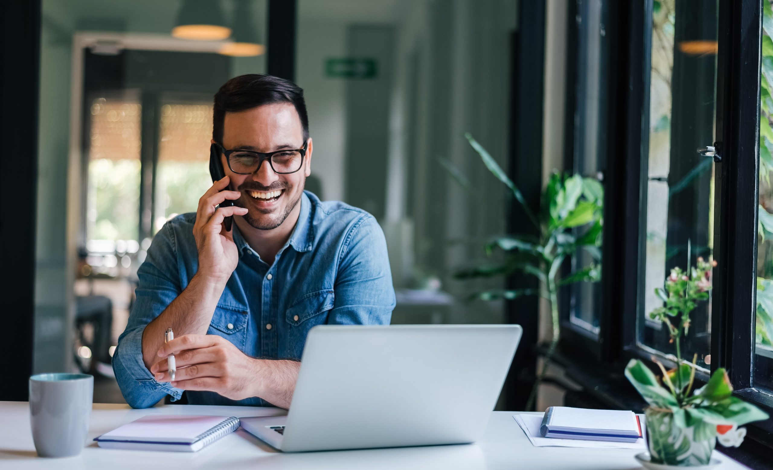 Portrait of young smiling cheerful entrepreneur in casual office